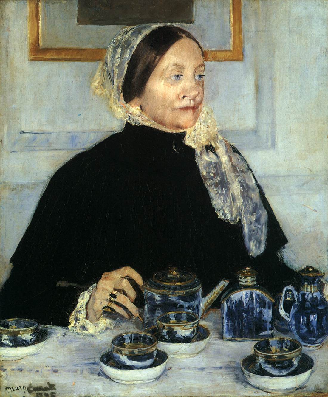Dame à la table du thé